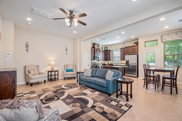 living room featuring light tile patterned flooring and ceiling fan