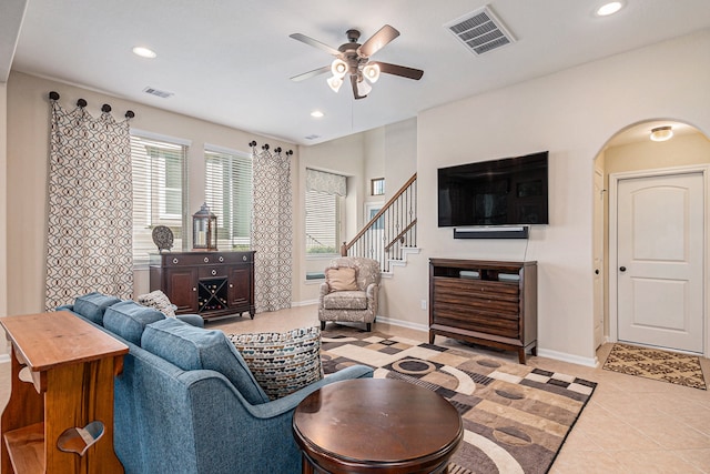 living room with light tile patterned flooring and ceiling fan