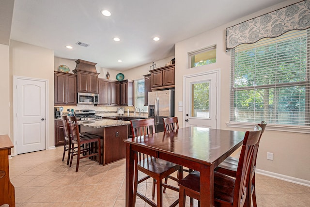 dining area with light tile patterned floors and sink