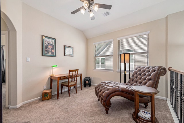 living area with carpet floors, vaulted ceiling, and ceiling fan