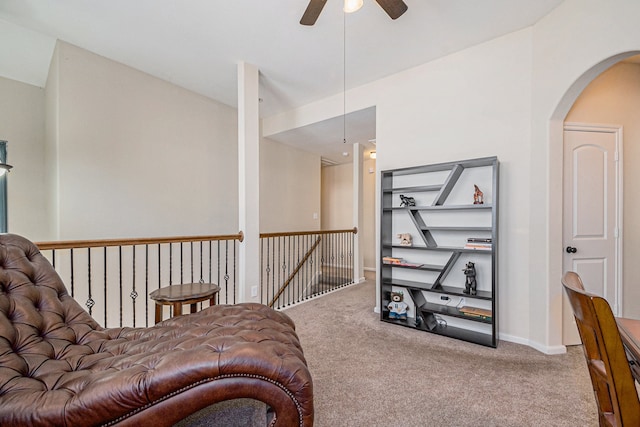 living area with carpet floors and ceiling fan