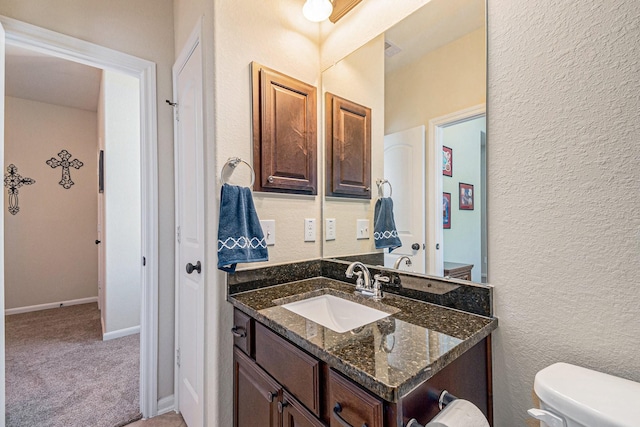 207 Cheswood Forest Pl, Montgomery, TX 77316 - bathroom with vanity, toilet, a textured wall, baseboards, and visible vents