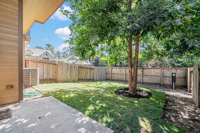 view of yard with cooling unit and a patio area