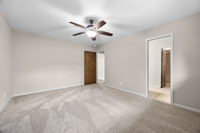 empty room with ceiling fan and light colored carpet