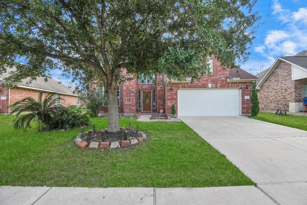 view of front facade with a garage and a front lawn