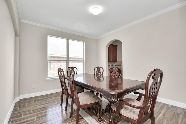 dining room featuring washer / dryer, dark wood-type flooring, and ornamental molding