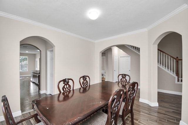 dining area with crown molding and dark wood-type flooring