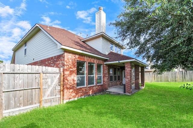 rear view of property featuring a patio and a lawn