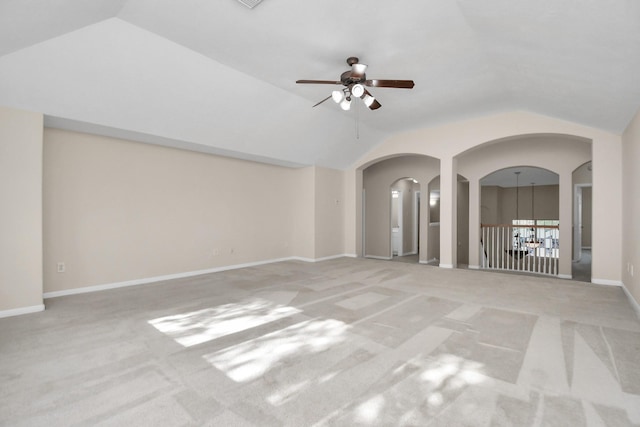 empty room featuring ceiling fan, light colored carpet, and vaulted ceiling