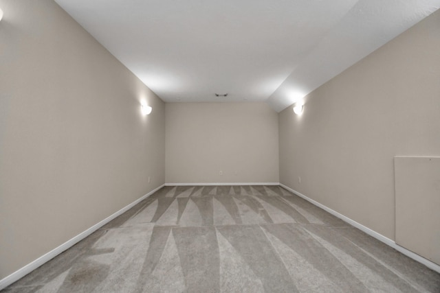 empty room with light carpet and lofted ceiling