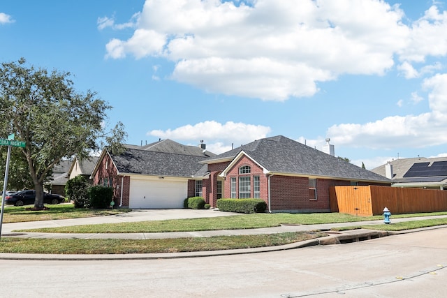 ranch-style home featuring a front lawn and a garage