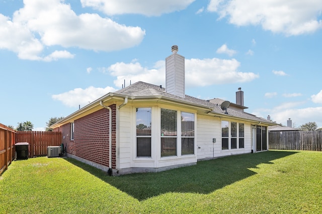 back of house with a lawn and central AC