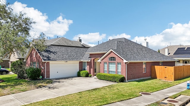 view of front facade with a garage and a front lawn