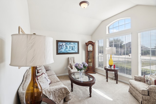 sitting room with lofted ceiling and light carpet