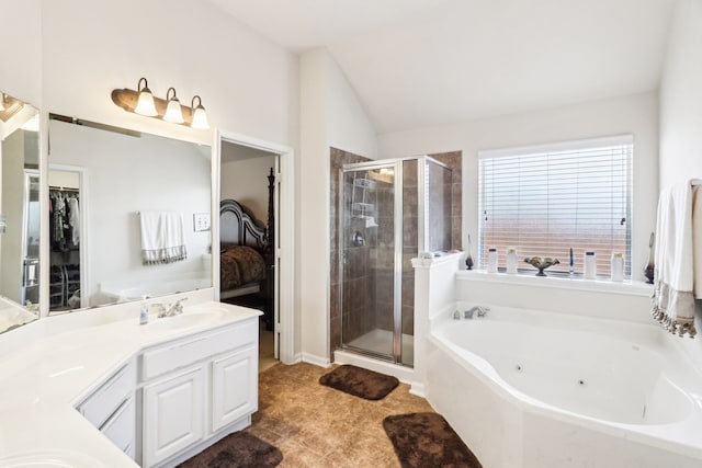 bathroom featuring shower with separate bathtub, vaulted ceiling, vanity, and tile patterned floors