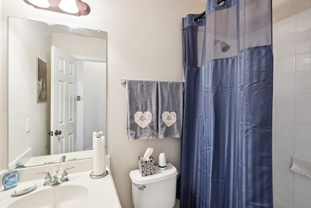 bathroom with walk in shower, toilet, and sink