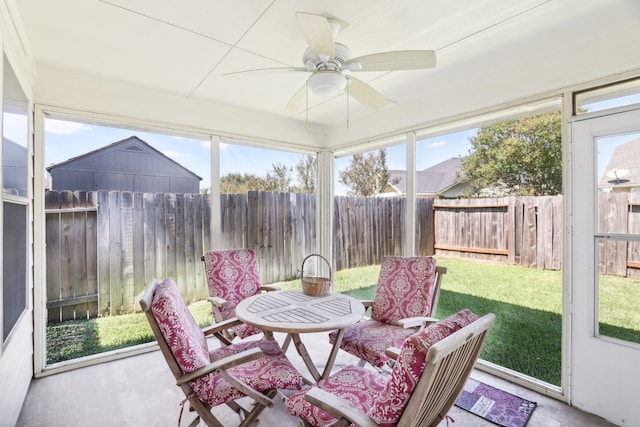 sunroom featuring ceiling fan and plenty of natural light