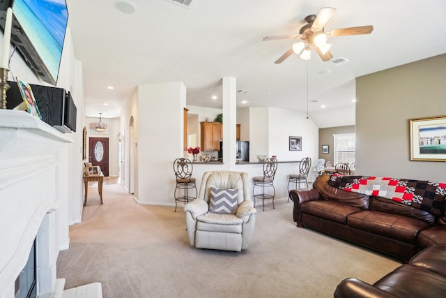 carpeted living room with ceiling fan