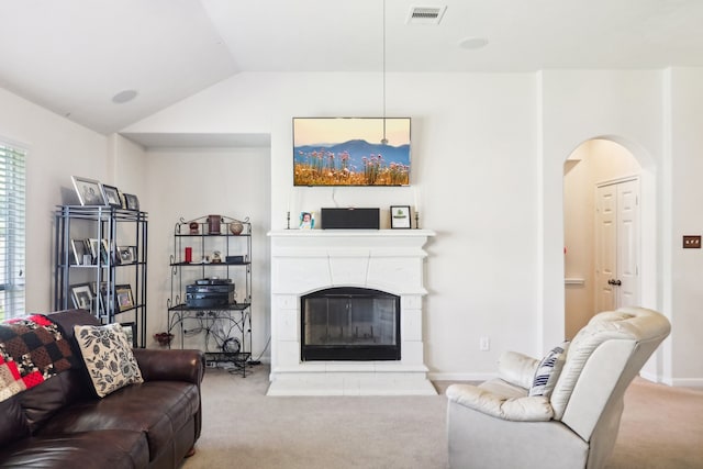 carpeted living room with lofted ceiling