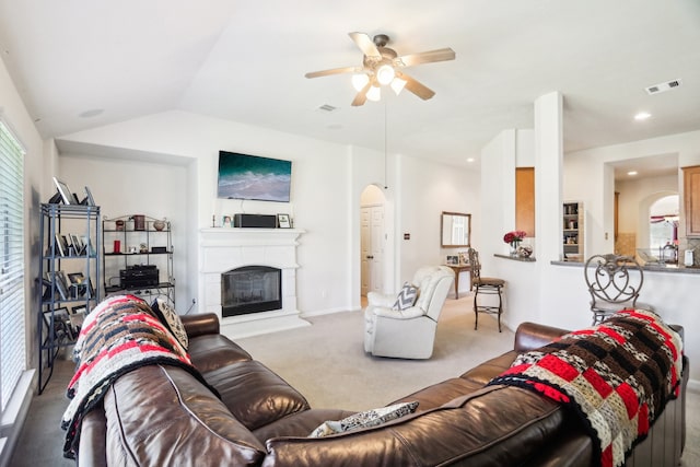 carpeted living room with vaulted ceiling and ceiling fan