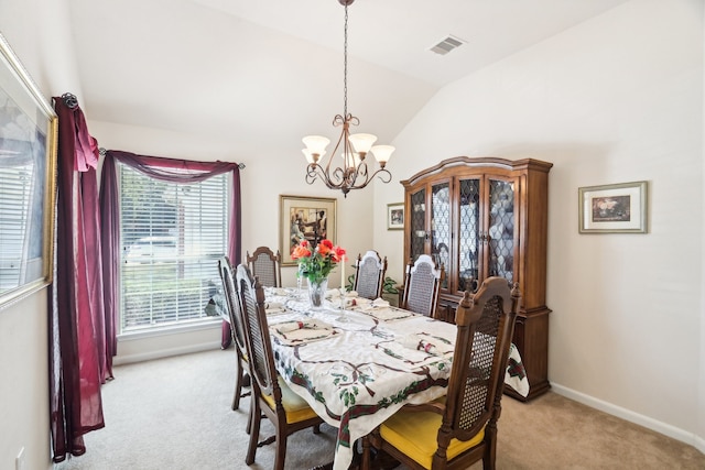 dining space featuring a notable chandelier, lofted ceiling, and light colored carpet