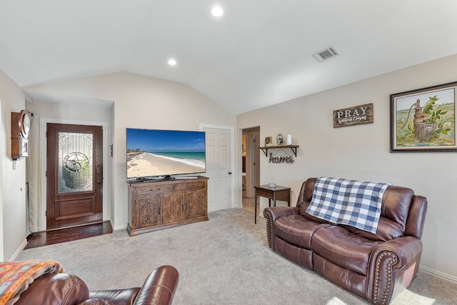 carpeted living room featuring vaulted ceiling