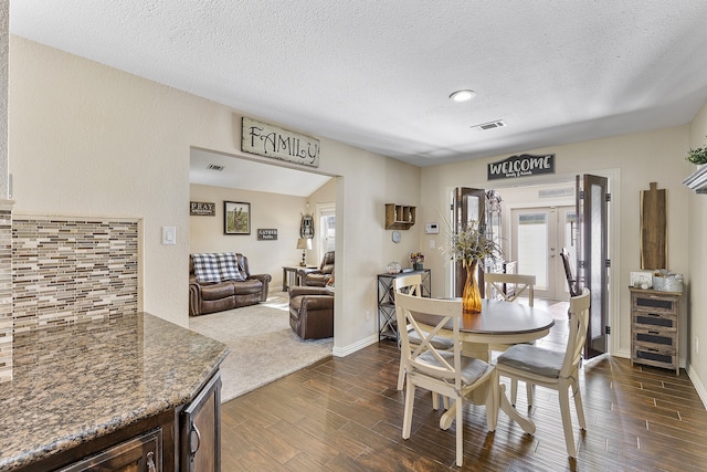 dining area with beverage cooler, a textured ceiling, and dark hardwood / wood-style flooring