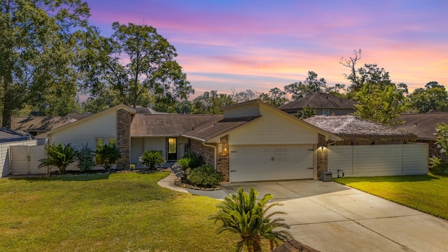 view of front of home with a garage and a yard