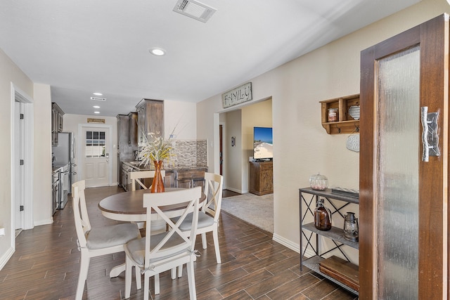 dining space featuring dark hardwood / wood-style floors