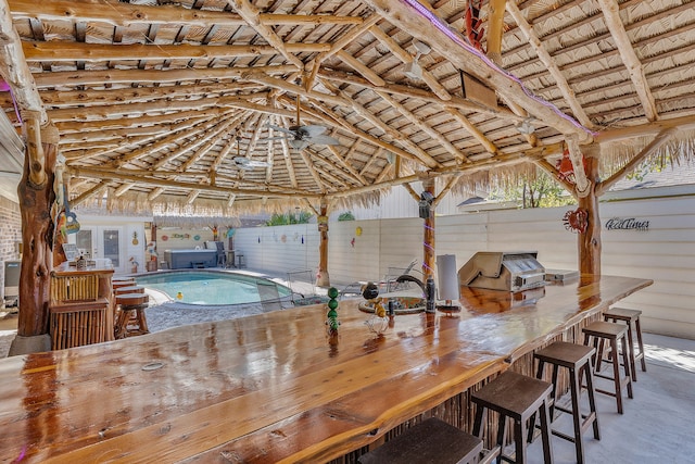 view of swimming pool with a gazebo, ceiling fan, a patio area, an outdoor bar, and a hot tub