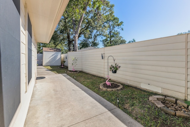 view of patio featuring a storage shed