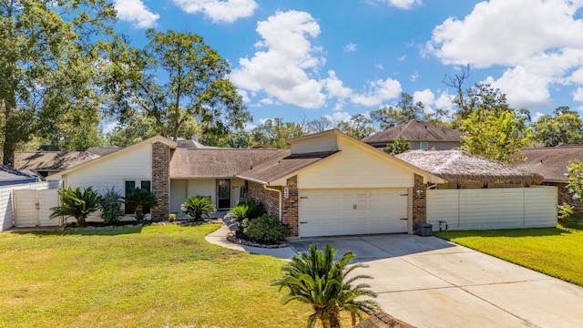 view of front of property featuring a garage and a front lawn