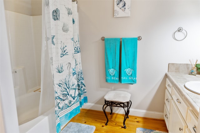 bathroom featuring vanity, shower / bath combo with shower curtain, and wood-type flooring