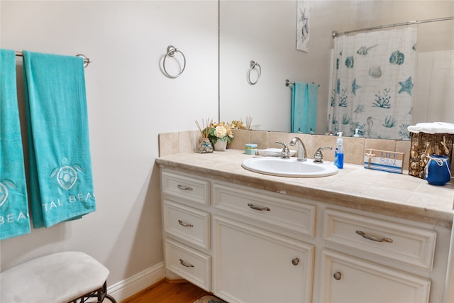 bathroom featuring vanity, tasteful backsplash, and hardwood / wood-style floors