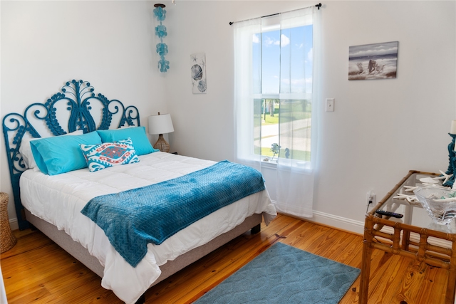 bedroom with hardwood / wood-style floors