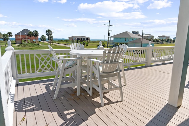 wooden deck featuring a lawn