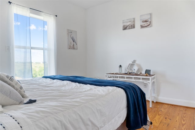 bedroom with hardwood / wood-style floors