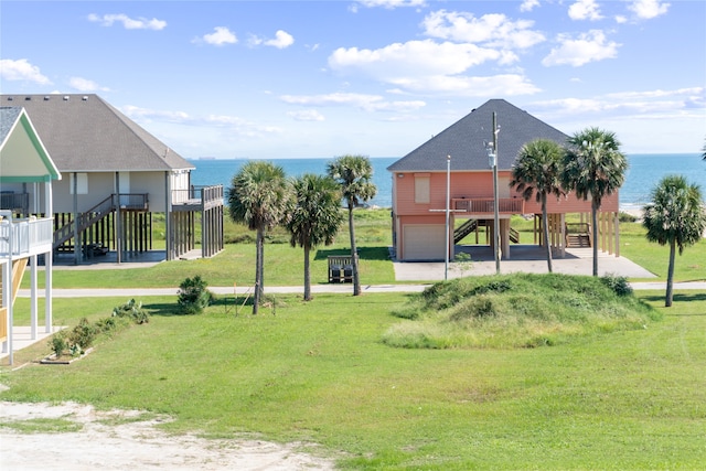 view of community with a water view and a lawn