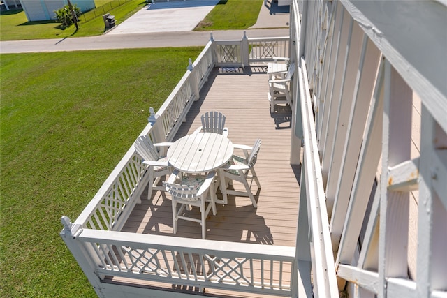 wooden terrace featuring a lawn