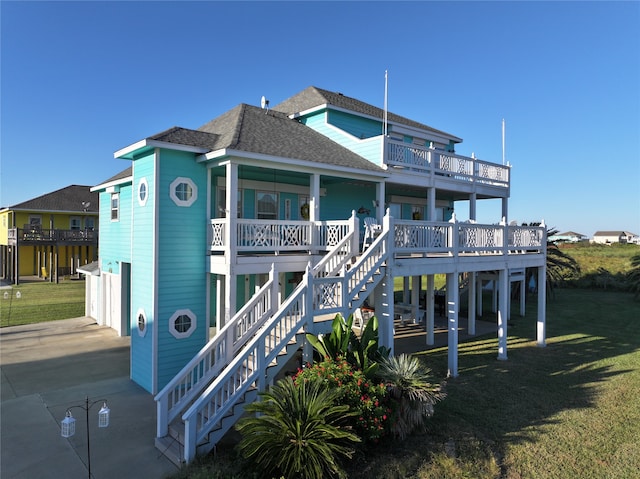 back of property featuring a porch and a lawn