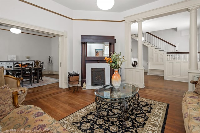 living room with dark wood-type flooring and a brick fireplace