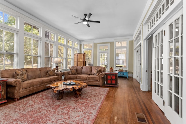 sunroom / solarium featuring ceiling fan