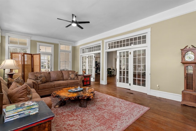 living room featuring ceiling fan, dark wood-type flooring, and french doors