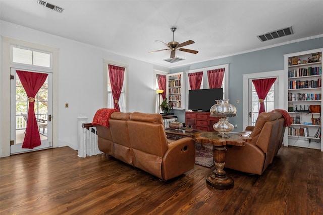 living room with ceiling fan, plenty of natural light, and dark wood-type flooring