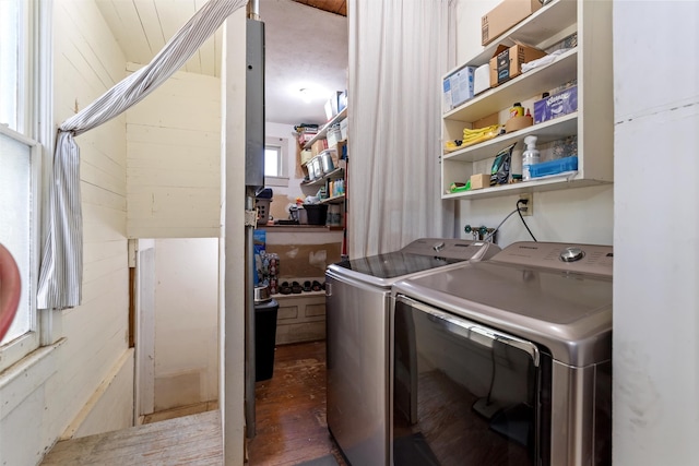 laundry area featuring separate washer and dryer and dark wood-type flooring