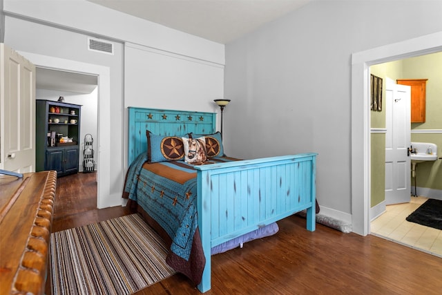 bedroom with dark hardwood / wood-style floors