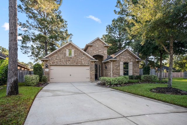 view of front of property with a front yard and a garage