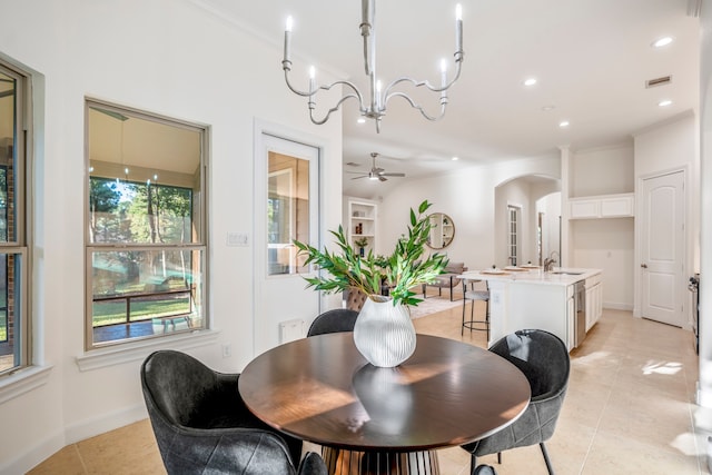 tiled dining room featuring ceiling fan with notable chandelier and ornamental molding