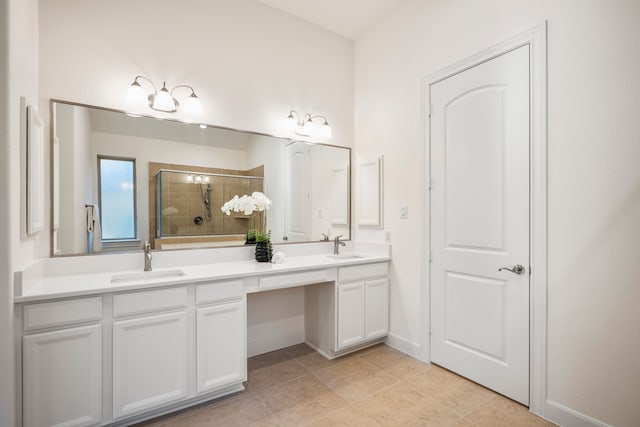 full bathroom featuring a stall shower, tile patterned flooring, a sink, and double vanity