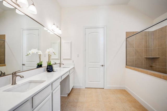 full bath with vaulted ceiling, double vanity, tile patterned flooring, and a sink